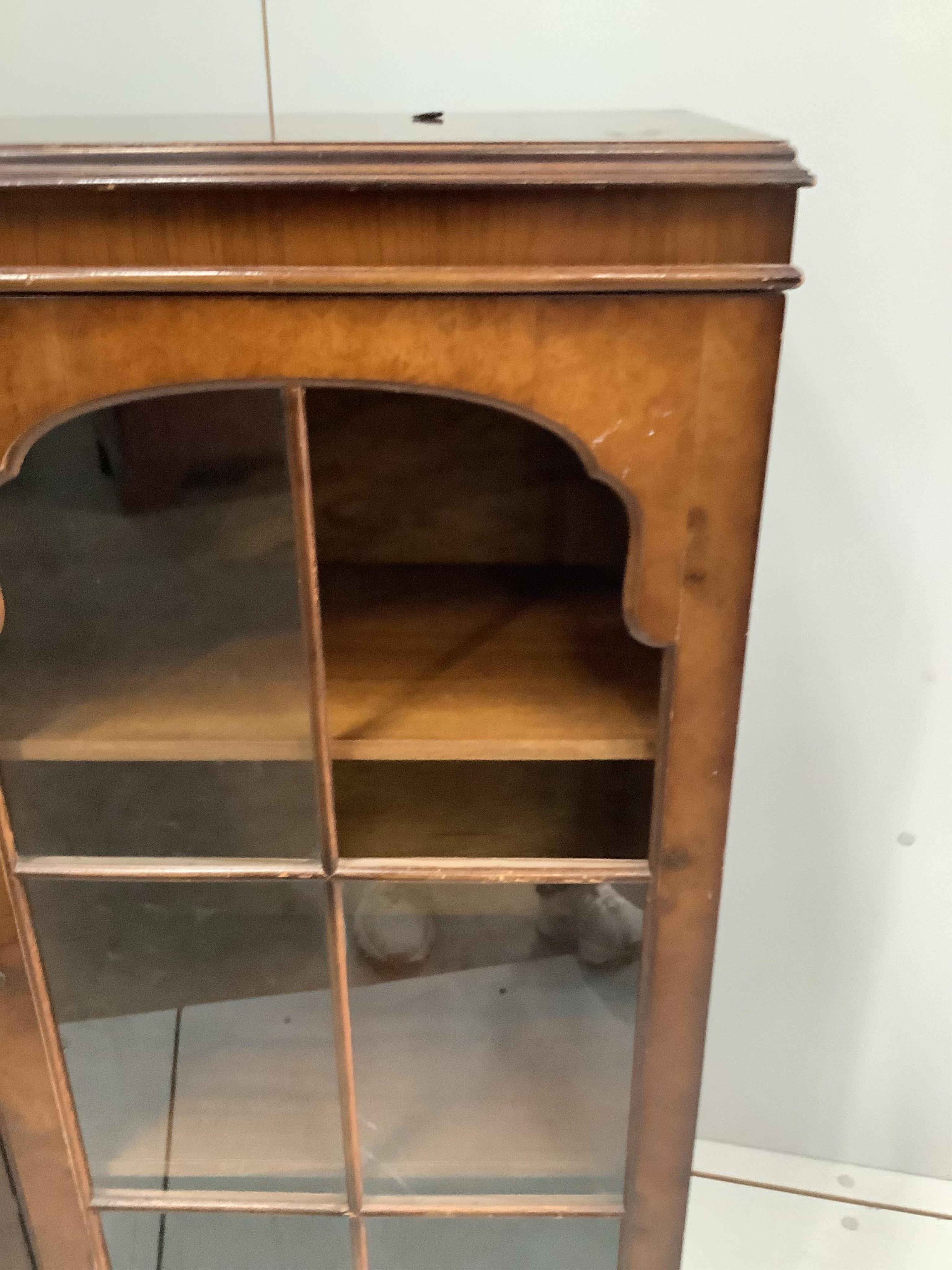 A Queen Anne Revival walnut bookcase, width 133cm, depth 30cm, height 109cm. Condition - poor